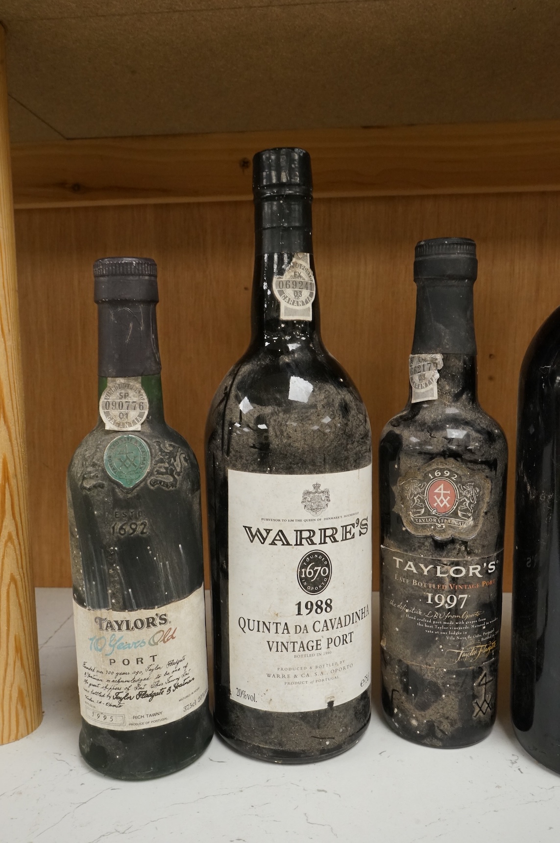Two bottles of Warres 1988 vintage Port, a half bottle of Taylor's 1997, a Taylor's 10 year old Port, and two bottles of Chateau Lartigue, 2004